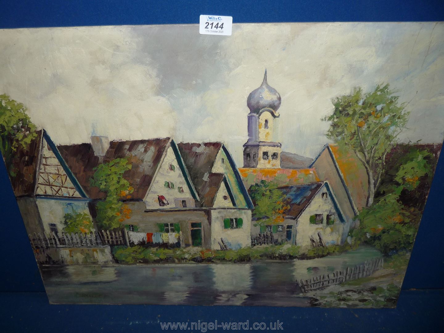 An unframed Oil on board depicting river flowing past houses and buildings, signed lower left J.