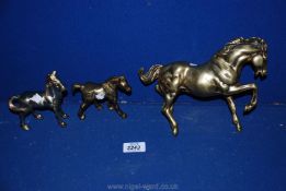 Three brass horses.