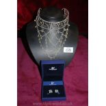 A Swarovski boxed choker and a boxed pair of earrings.