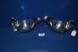 A pair of silver gravy sauce boats with scalloped edge and hoof feet, marked Sheffield, 1899,