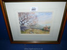 A small framed Watercolour of a country landscape with mountain in distance, signed lower left K.