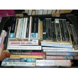 Two boxes of soft back Novels including Peter Hopkirk, Jeremy Paxman, Dick Francis, etc.