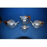 Four pieces of Picquot ware including two teapots, water jug and milk jug.