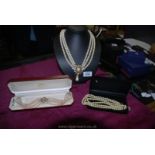 Three simulated pearl necklaces including Trifari choker, a choker in lotus box and one other.