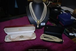 Three simulated pearl necklaces including Trifari choker, a choker in lotus box and one other.