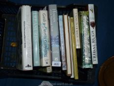 A crate on books on Tribal rugs, Wild flowers of the World, Season of birds, etc.