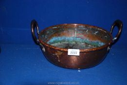 A shallow two handled copper pan, 4 1/2" deep x 11 3/4" diameter.