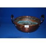 A shallow two handled copper pan, 4 1/2" deep x 11 3/4" diameter.