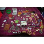 A box of costume jewellery including West German tie pin, brooches etc.