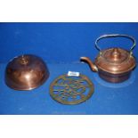 A small copper kettle, decorated brass trivet and a copper crumpet cover.