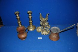 A pair of brass candlesticks with ejectors, a brass vine leaf table centre,