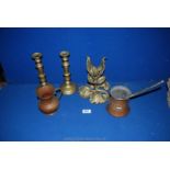 A pair of brass candlesticks with ejectors, a brass vine leaf table centre,