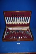 A wooden cased canteen of plated cutlery, six place and including a carving knife and fork,