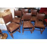 A set of six robust Oak framed dining chairs with brown Rexine seats and backs.
