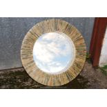 A novel contemporary circular framed wall-mirror, 29'' diameter.