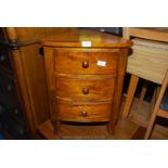 An Eastern hardwood rounded triangular-shaped, three drawer corner unit, 24'' high x 17'' x 17''.