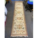 A cream ground Carpet Runner, 26½" x 106" approx.