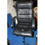 A black leather type swivel office executive's chair