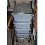 A chromium plated trolley-mounted set of four plastic drawers.