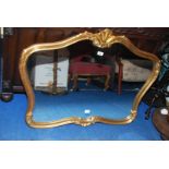 A shaped, gilt-finished framed wall-hanging mirror. 40'' wide x 30'' high.