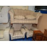 A lounge suite comprising a two seater settee and a pair of chairs.