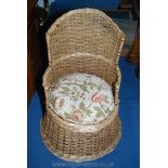 A Wicker tub style upholstered seated chair.