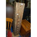 A heavy, drilled timber beam pillar wine bottle stand.