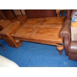 A hardwood Coffee table having four-panelled top and standing on turned and lobed bulbous legs.