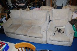 A beige upholstered three seater settee and a matching electrically-adjusting chair.