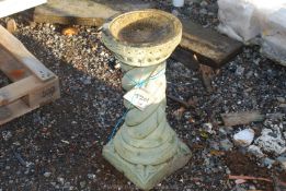 A concrete bird bath.