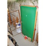 A 6' snooker table on a metal frame. Balls present..