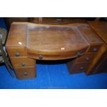 An Oak bow-fronted dressing table with three drawers to either side. 45'' x 21'' deep x 29'' high.