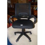 A stylish black upholstered swivel office arm-chair.