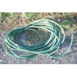 A coil of larger than normal diameter reinforced water hose.