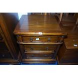 A contemporary dark hardwood three-drawer chest/storage unit.