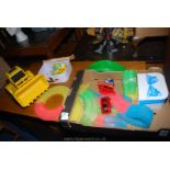A child's Glow Tracks racing game with track and two cars, a bright yellow digger/earth mover,