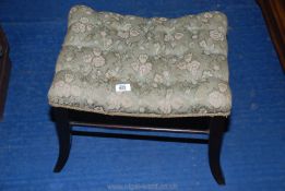 An upholstered piano stool.