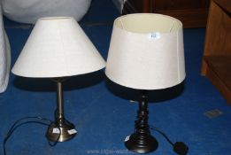 Two modern table lamps and cream/white shades.