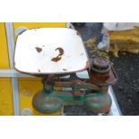 A Siddon's Metal kitchen scales and two weights.