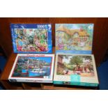 Four 1000 piece jig-saw puzzles.