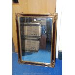 A gilt type framed bevel plate wall-hanging mirror. 42'' x 29''.