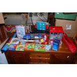 A box of games and toys including Five Little Ducks, Match and Learn,