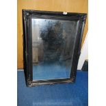 A black finish framed bevel-plate wall mirror. 36'' x 26''.