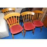 A set of four upholstered-seated kitchen chairs.