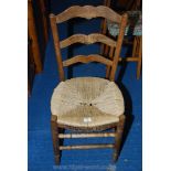 A seagrass seated ladder back side chair.