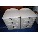 Pair of cream finish two-drawer bedside cabinets with drawers and pull out shelves.