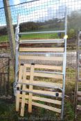 A Metal single bed with wooden slats.