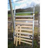 A Metal single bed with wooden slats.