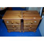 A pair of Pine three-drawer bedside cabinets. 18'' wide x 23'' high x 15'' deep.