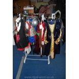 A clothes rail of children's fancy dress clothes including Knights, Pirates, a Princess, a Soldier,